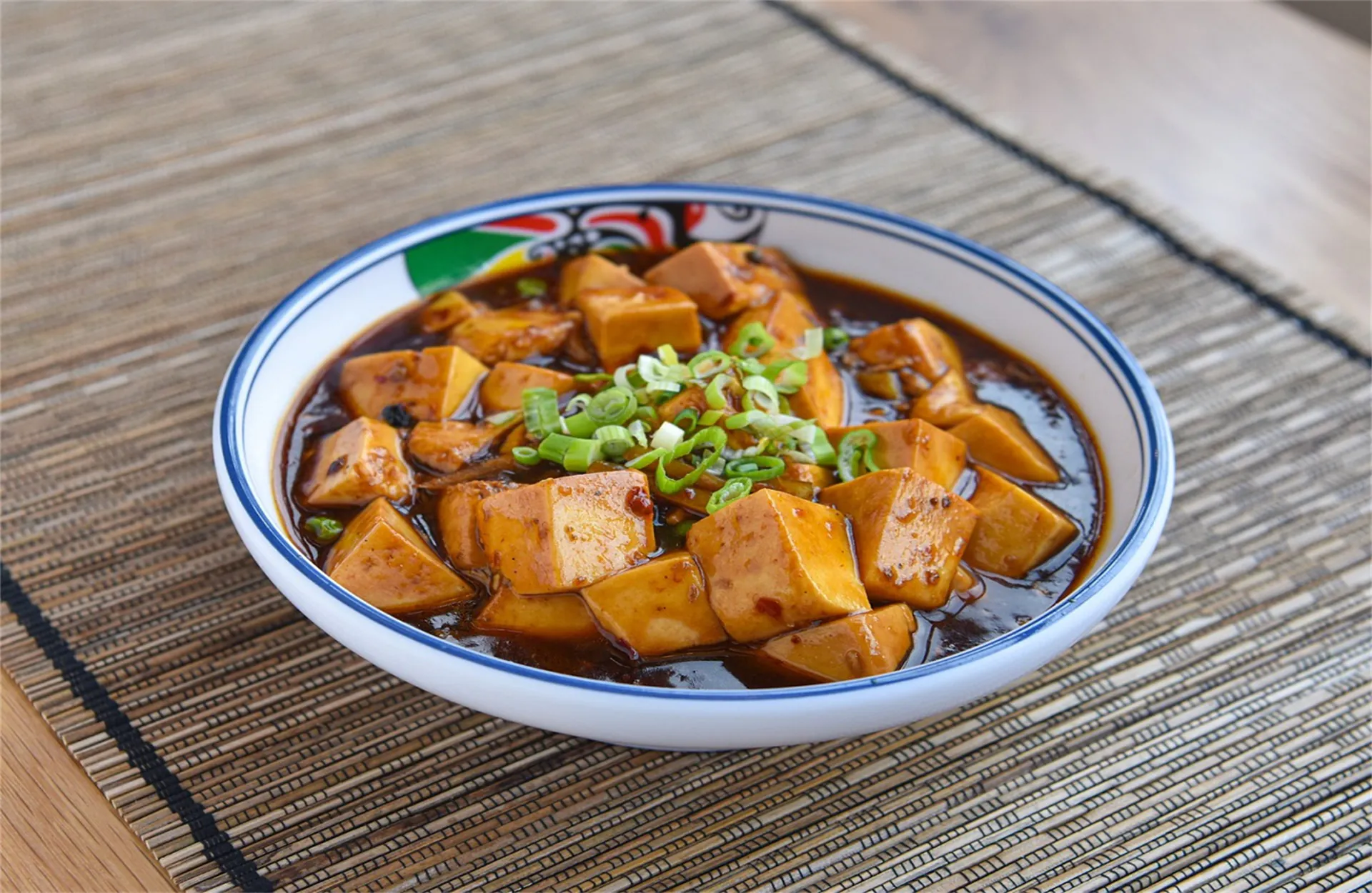 Spicy Sichuan-style tofu in savory sauce with scallions at Asia Express, a Chinese Restaurant in Philadelphia.