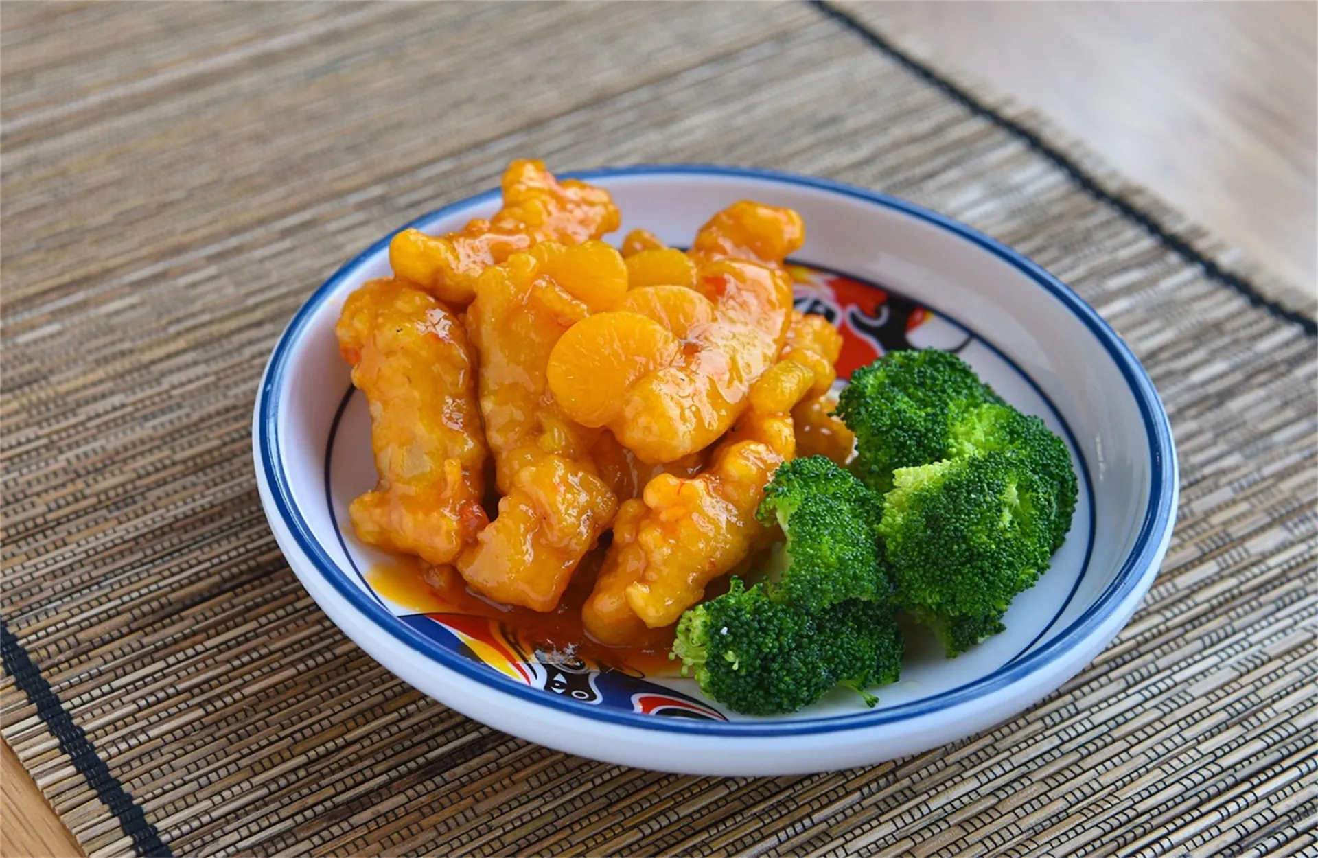 Crispy chicken in tangy sweet-sour sauce with broccoli at Asia Express, a Chinese Restaurant in Philadelphia.
